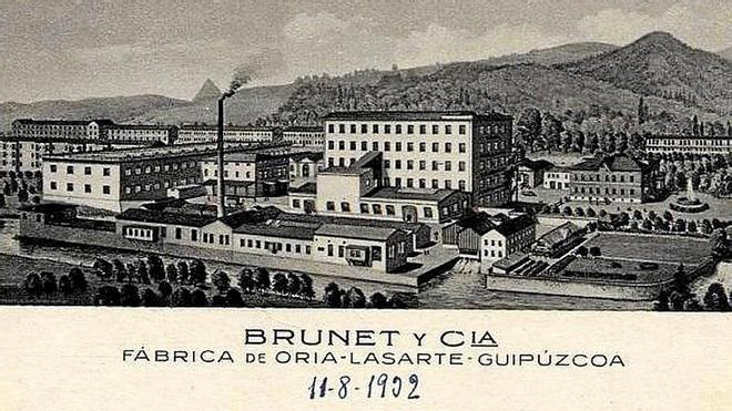 Ilustración de las instalaciones Brunet y Cía, con fábrica, chimenea, construcciones bajas y jardines